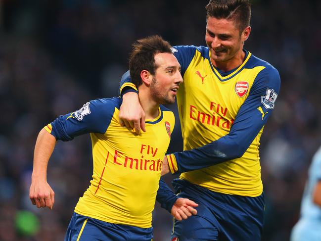 MANCHESTER, ENGLAND - JANUARY 18: Santi Cazorla of Arsenal (L) celebrates with Olivier Giroud as he scores their first goal from a penalty during the Barclays Premier League match between Manchester City and Arsenal at Etihad Stadium on January 18, 2015 in Manchester, England. (Photo by Alex Livesey/Getty Images)