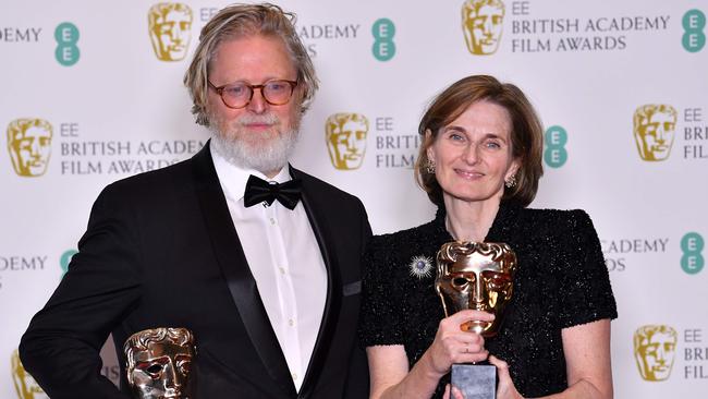 Deborah Davis, right, and Tony McNamara pose with their awards for an Original Screenplay for The Favourite. Picture: AFP