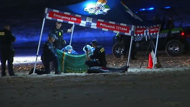 Police at the crime scene set up on the beach in the early hours of Monday morning. MUST Picture: 9NEWS