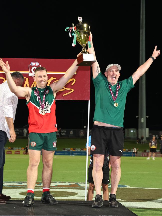 South Cairns Cutters captain Beau McKeown and coach Daryn Cresswell lift the premiership trophy after winning the AFL Cairns men's grand final match on his fourth attempt, defeating the North Cairns Tigers at Cazalys Stadium, Westcourt. Picture: Brendan Radke