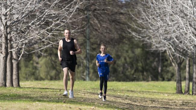 Brad Hixon, 11, jogging with his big brother Ben, nearly 18 months after sustaining a serious injury in his first season of rugby league. Picture: Matthew Vasilescu