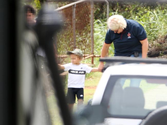 A woman (left) and child leaving a house following a siege in Sunnybank. Picture: Tara Croser