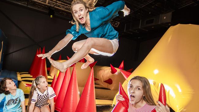 Gold Coast kids Jae Chapman, 9, Kyra Sutton, 9 and Alexandra Cotterill, 13 watch in awe of golden girl and ex Olympic hurdler Sally Pearson as she takes on Dreamworld's newest attraction just in time for the school holidays, The Monster. Picture: Nigel Hallett