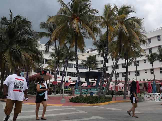 People walk past the Clevelander South Beach Hotel which announced it was closing again over COVID-19 concerns. Picture: AFP