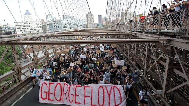 US protesters walk over the Brooklyn Bridge following a memorial service for George Floyd, the man killed by a Minneapolis police officer. Picture: Justin Heiman/Getty Images