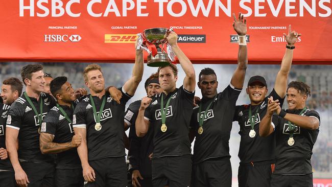 New Zealand pose with the trophy after winning the Cape Town Sevens cup final.