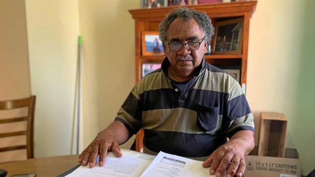 Ross Sauney looks over the documents he has kept about his father&#39;s stolen wages. Picture: Caitlan Charles