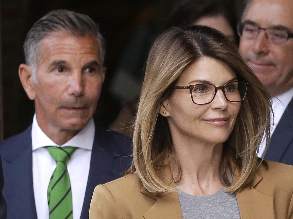 Lori Loughlin, front, and husband, clothing designer Mossimo Giannulli, left, depart federal court in Boston after facing charges last week. Picture: AP Photo/Steven Senne. 