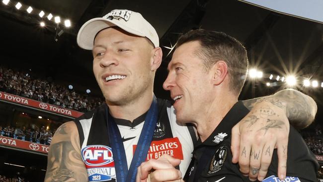 MELBOURNE, AUSTRALIA - SEPTEMBER 30: Jordan De Goey of the Magpies and Craig McRae, Senior Coach of the Magpies embrace after the 2023 AFL Grand Final match between Collingwood Magpies and Brisbane Lions at Melbourne Cricket Ground, on September 30, 2023, in Melbourne, Australia. (Photo by Darrian Traynor/AFL Photos/via Getty Images)