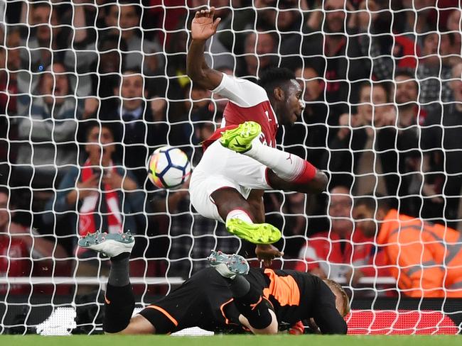 Danny Welbeck of Arsenal collides with Kasper Schmeichel of Leicester City as he scores his team's second goal.