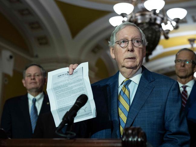 WASHINGTON, DC - MARCH 7: Senate Minority Leader Mitch McConnell (R-KY) holds up a letter from the U.S. Capitol Police as he denounces Fox News' Tucker Carlson's recent coverage of the January 6, 2021 attack on the Capitol, during a news conference at the U.S. Capitol on March 7, 2023 in Washington, DC. McConnell spoke on a range of issues after a closed-door lunch meeting with Senate Republicans.   Drew Angerer/Getty Images/AFP (Photo by Drew Angerer / GETTY IMAGES NORTH AMERICA / Getty Images via AFP)