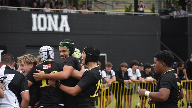 Xavier Santos (second from the right) getting around Ben Davis and other Laurie's teammates after a Finn Mackay try.