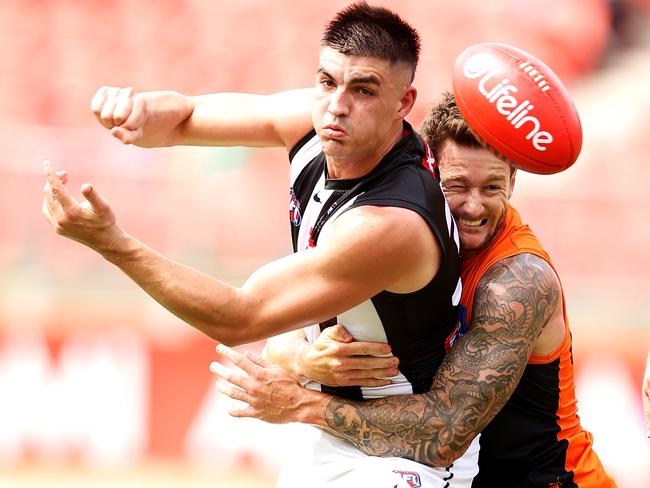 SYDNEY, AUSTRALIA - MARCH 06: Brayden Maynard of the Magpies passes as he is tackled during the AFL AAMI Community Series match between the Greater Western Sydney Giants and the Collingwood Magpies at GIANTS Stadium on March 06, 2022 in Sydney, Australia. (Photo by Mark Kolbe/Getty Images)