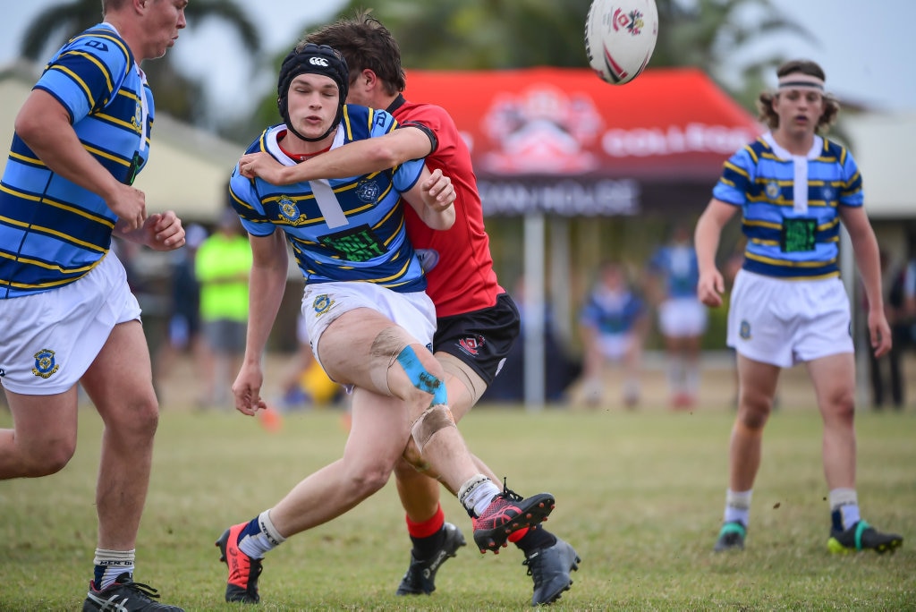 Riley Shaw - St Columban's College, Caboolture kicks as he is tackled by Rylee Johnson Shalom College, Bundaberg