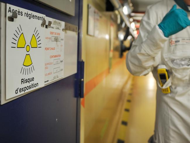 A technician stands next a control area inside the building housing the switched off Unit 2 reactor at the nuclear power plant of Chinon.  A French nuclear power reactor has been shut down for additional testing, the nation's regulator said on June 16, 2016 as Greenpeace called for full disclosure of facilities using possibly faulty parts from Areva. / AFP PHOTO / GUILLAUME SOUVANT