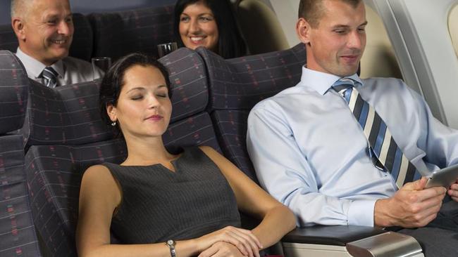 The guy in the back looks pretty happy, so she must have followed our five golden rules for reclining aeroplane seats. Picture: Thinkstock