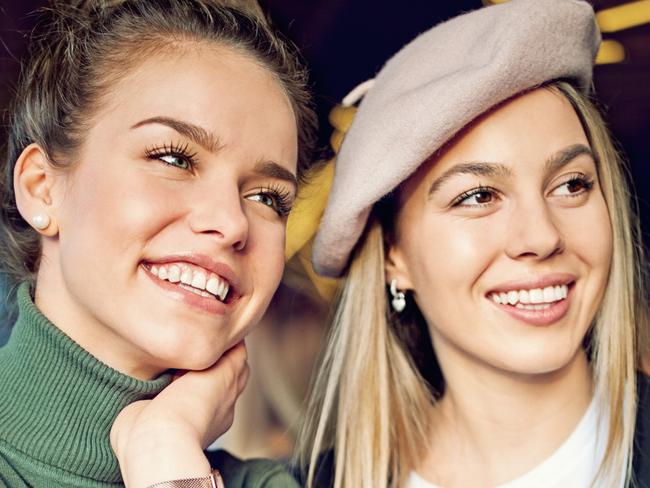 Girlfriends are paying their cocktails using contactless credit card in the bar