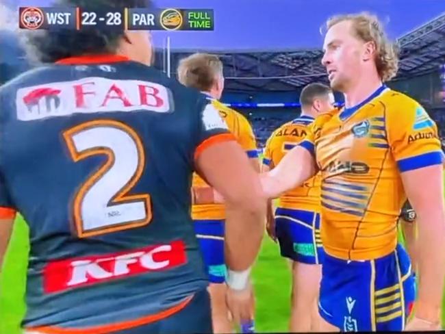 Eels captain Clint Gutherson and Wests Tigers win Asu Kepaoa share a cold exchange after the match.