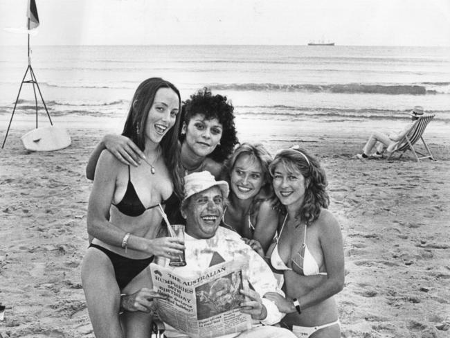 Barry Humphries, in character as Sir Les Patterson, with his assistants on Bondi Beach in 1984.