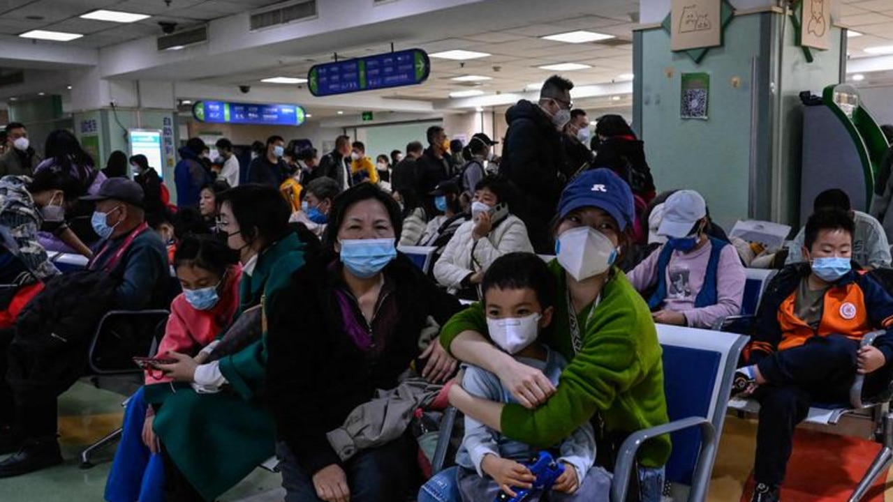 Children and their parents wait at an outpatient area at a children hospital in Beijing on November 23. Picture: AFP