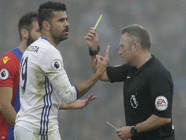 Diego Costa is shown a yellow card. (AP Photo/Matt Dunham)