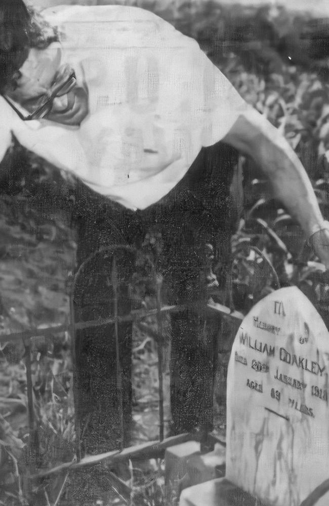 Grandson of William "Billy" Coakley, Harry Chambers Coakley, checks his grandfather’s grave. (Daily Mercury, October 24, 1966)