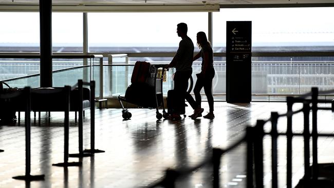 Travellers arrive to check in to one of only a handful of departing flights at the Brisbane international airport. Picture: AAP