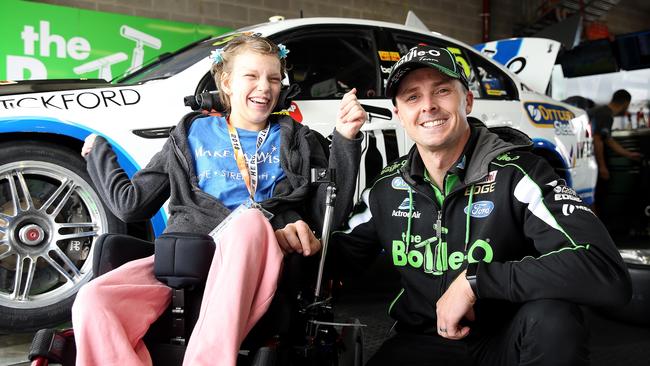 Mark Winterbottom with Angel Henderson in his garage at Mount Panorama Raceway. Picture: Tim Hunter