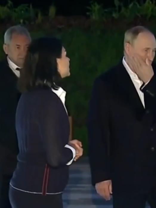 Putin's right arm looks limp as he uses his left arm to swat away the mosquitos.