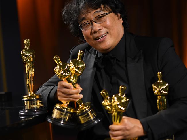 TOPSHOT - South Korean film director Bong Joon Ho poses with his engraved awards as he attends the 92nd Oscars Governors Ball at the Hollywood & Highland Center in Hollywood, California on February 9, 2020. (Photo by VALERIE MACON / AFP)