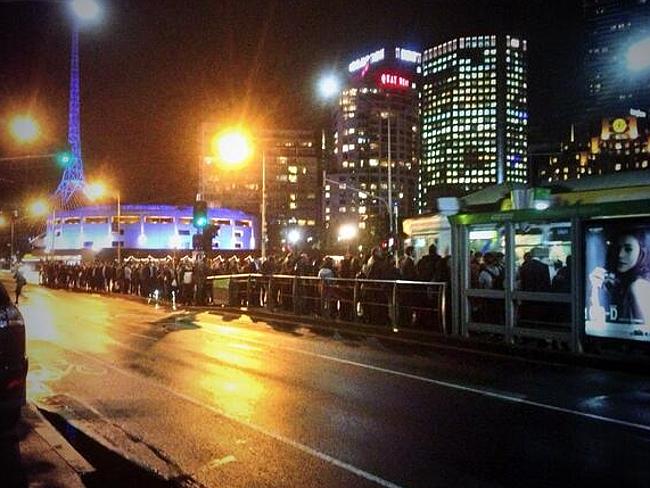 People queue for trams in Melbourne after a fire in Richmond stopped trains to the eastern suburbs.