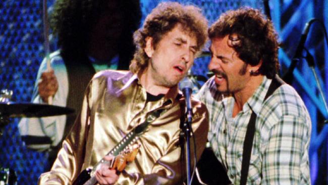 Bruce Springsteen with Bob Dylan during a 1995 benefit concert in Cleveland.