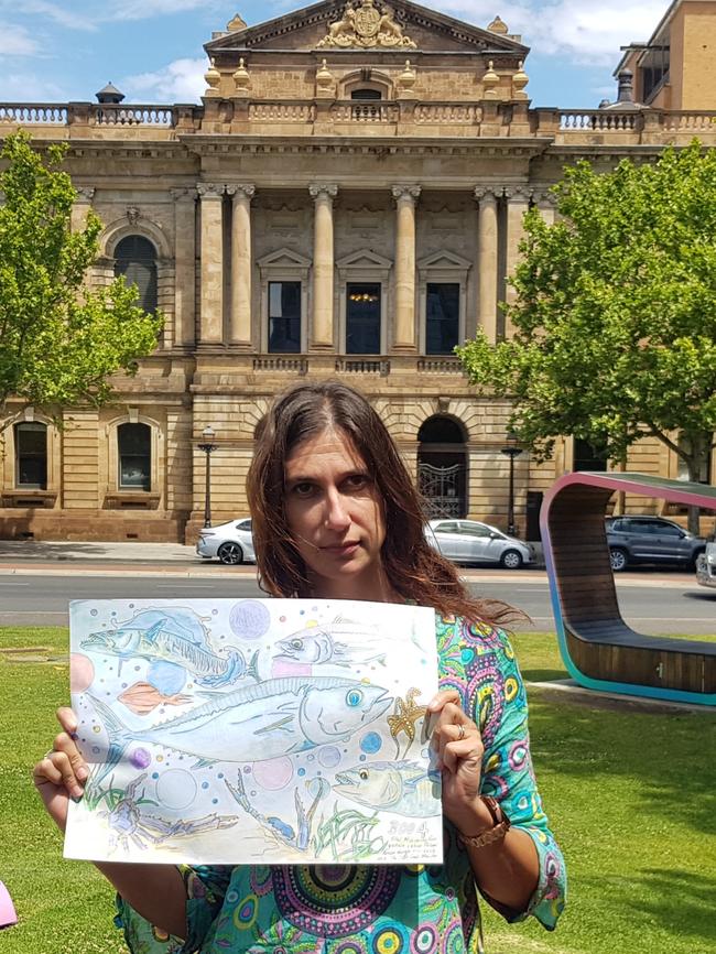 Kendehl, the daughter of Salt Creek backpacker kidnapper Roman Heinze with one of his artworks outside of court. Picture: Sean Fewster