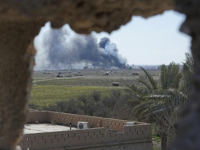 Columns of black smoke billow from the last small piece of territory held by Islamic State militants as U.S. backed fighters pounded the area with artillery fire and occasional airstrikes in Baghouz, Syria, Sunday, March 3, 2019. (AP Photo/Andrea Rosa)