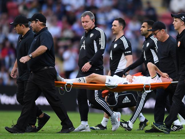 Leeds teenager Archie Gray leaves Suncorp Stadium in a stretcher. Picture: Albert Perez/Getty Images