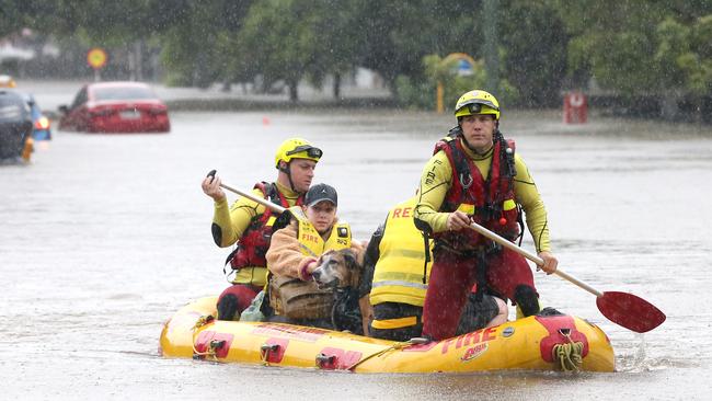 Adin Richardson and Karina Handall and Detroit the dog, were rescued from their house on from Haig Rd Milton. Picture: Steve Pohlner