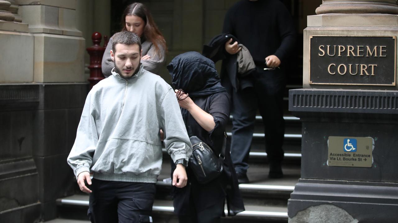 She covered her face as she left court with family in December last year. Picture: NewsWire.