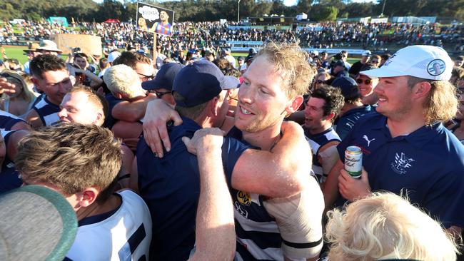 Yarrawonga’s Leigh Williams is swamped by the Pigeons crowd after the final siren.