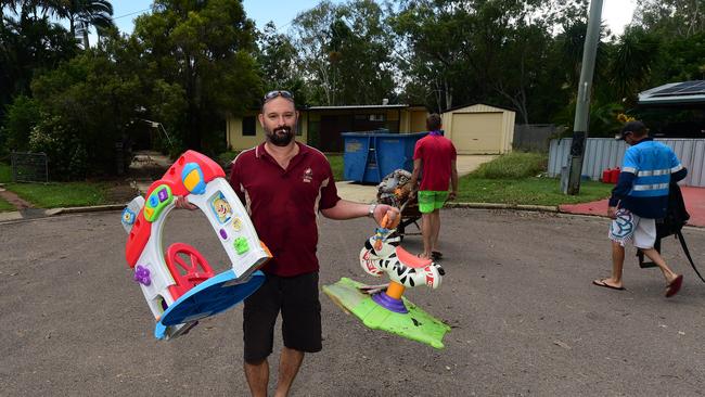 Flooding in Laura Court, Deeragun. Sean Koch helps to remove damaged goods from his mate's house, Daniel Hanran. Picture: Evan Morgan