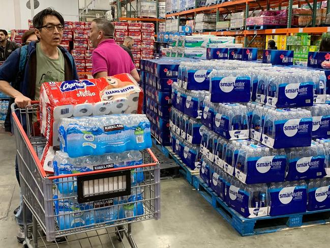 Shoppers stockpiling water, food and toilet paper. Picture: AFP