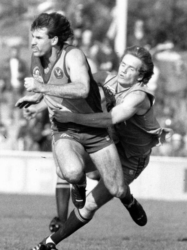 Sturt’s Scott Field tackles West Torrens’ Scott Morphett at Thebarton Oval in July 1988.