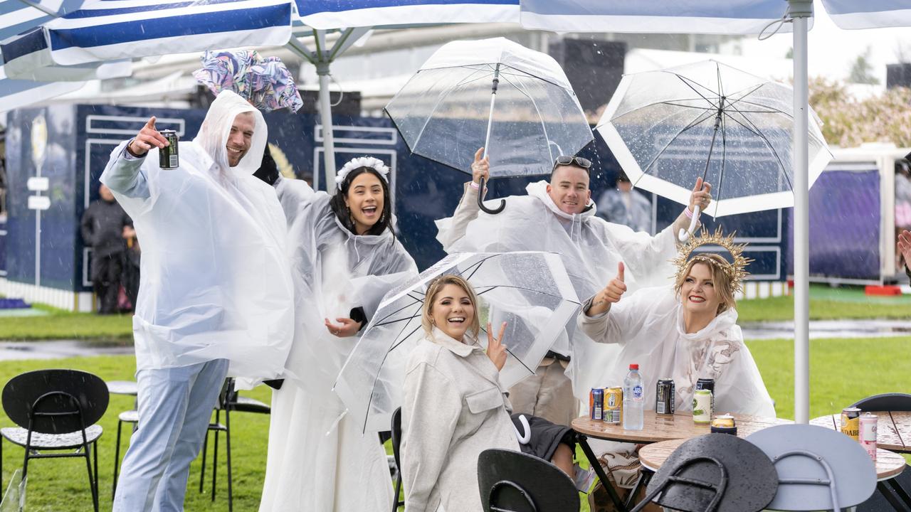 PLANNED AHEAD: Punters refuse to let itthe bad weather ruin their fun at Melbourne Cup Day at Flemington Racecourse. (Photo by Jay Town/Racing Photos via Getty Images)