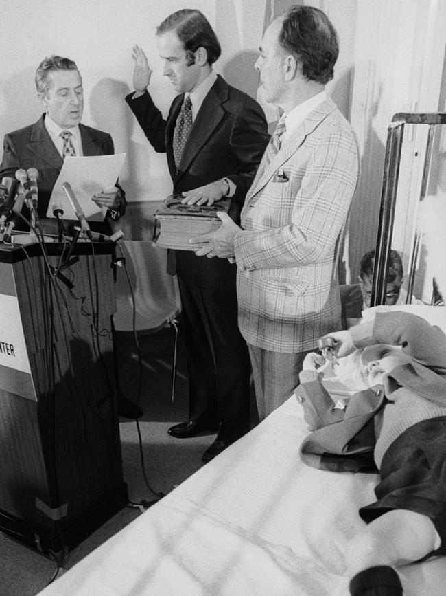 Senator Joseph Biden takes the oath of office with his father-in-law Robert Hunter and son Joseph Beau Biden at his side, in Beau's hospital room.