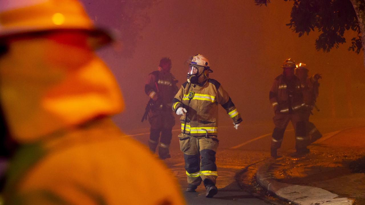 Fire and Rescue teams fight a wild bushfire as it approaches Peregian Beach township on David Low Way. Picture: Lachie Millard