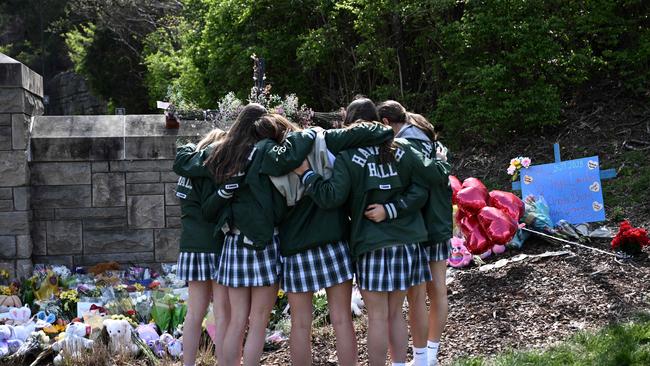 Girls embrace in front of a makeshift memorial for victims by The Covenant School building at The Covenant Presbyterian Church following the shooting. Picture: AFP