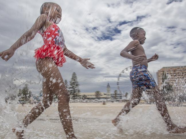 Hot Weather at Glenelg. Cooling off are Hlompho Kabi 8 (girl) and Keamohetswe Tsupa 10 (boy) 14th December 2024. Picture Brett Hartwig