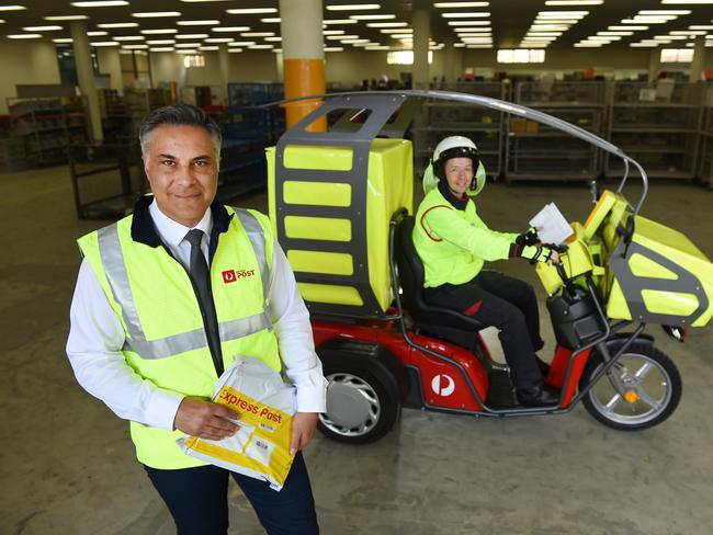 Aussie Post chief Ahmed Fahour and postie Ron Trevillian with new a delivery vehicle. Picture: David Smith