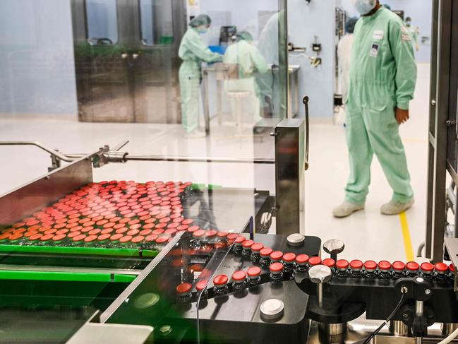 A laboratory technician supervises capped vials during filling and packaging tests for the large-scale production and supply of the University of Oxford’s COVID-19 vaccine candidate. Picture: AFP.