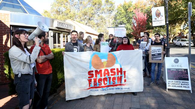 Protesters outside the meeting. AAP/Kelly Barnes