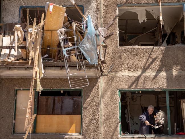 A man throws debris from the window of a residential apartment block in the Donbas region. A majority of Kramatorsk's civilian residents have fled the war. Picture: Chris McGrath/Getty Images